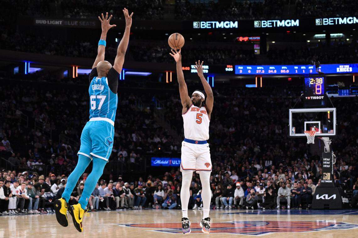 Oct 15, 2024; New York, New York, USA; New York Knicks forward Precious Achiuwa (5) shoots the ball while being defended by Charlotte Hornets forward Taj Gibson (67) during the first half at Madison Square Garden. Mandatory Credit: John Jones-Imagn Images