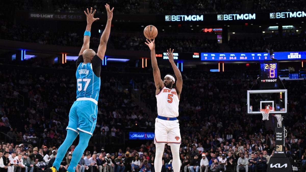 New York Knicks forward Precious Achiuwa (5) shoots the ball while being defended by Charlotte Hornets forward Taj Gibson (67) during the first half at Madison Square Garden.