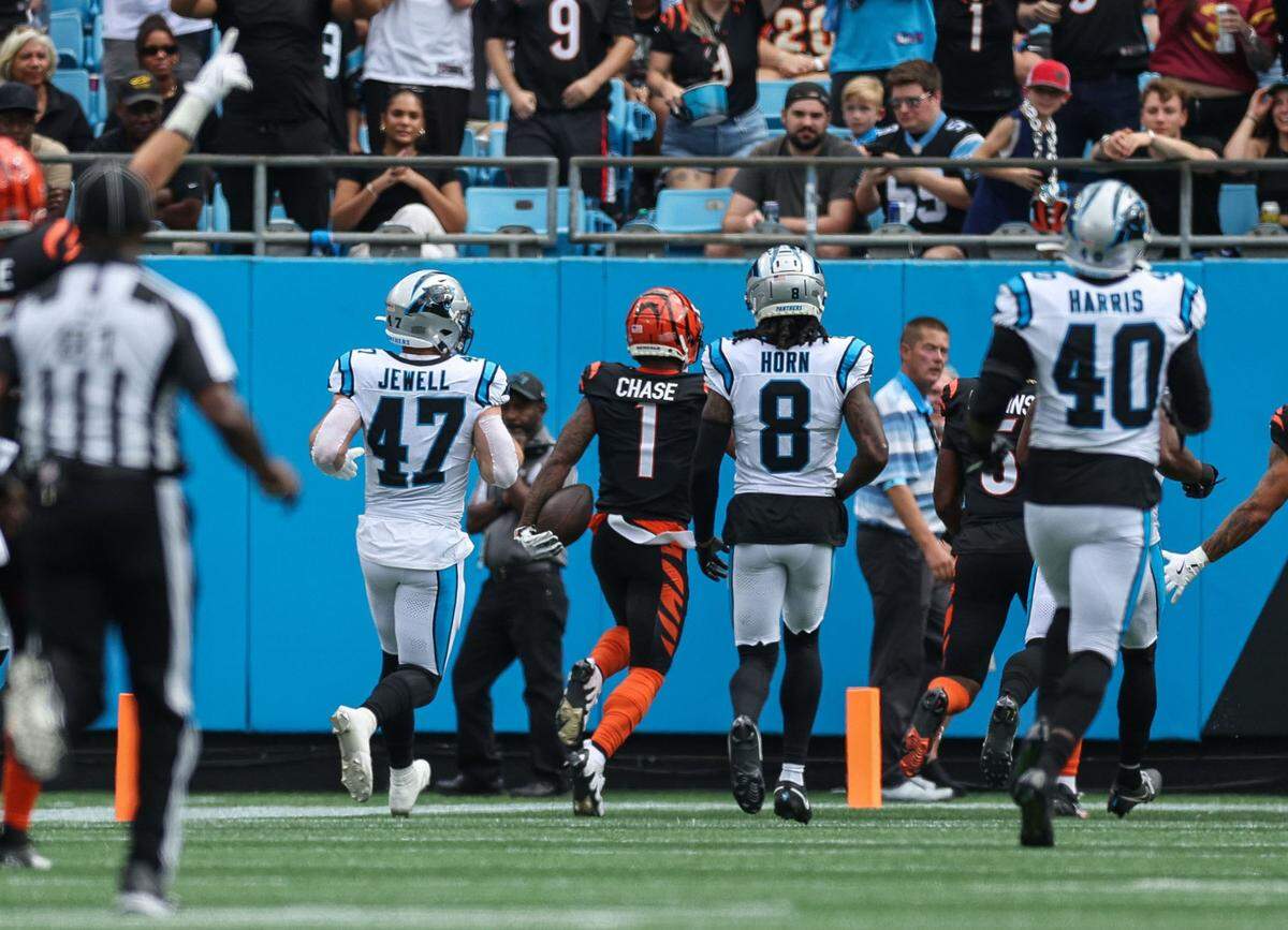 Bengals wide receiver Ja’Marr Chase (1) runs the ball into the end zone to finish a 63-yard touchdown against the Panthers. Carolina missed three tackles on the play. Cincinnati won, 34-24.