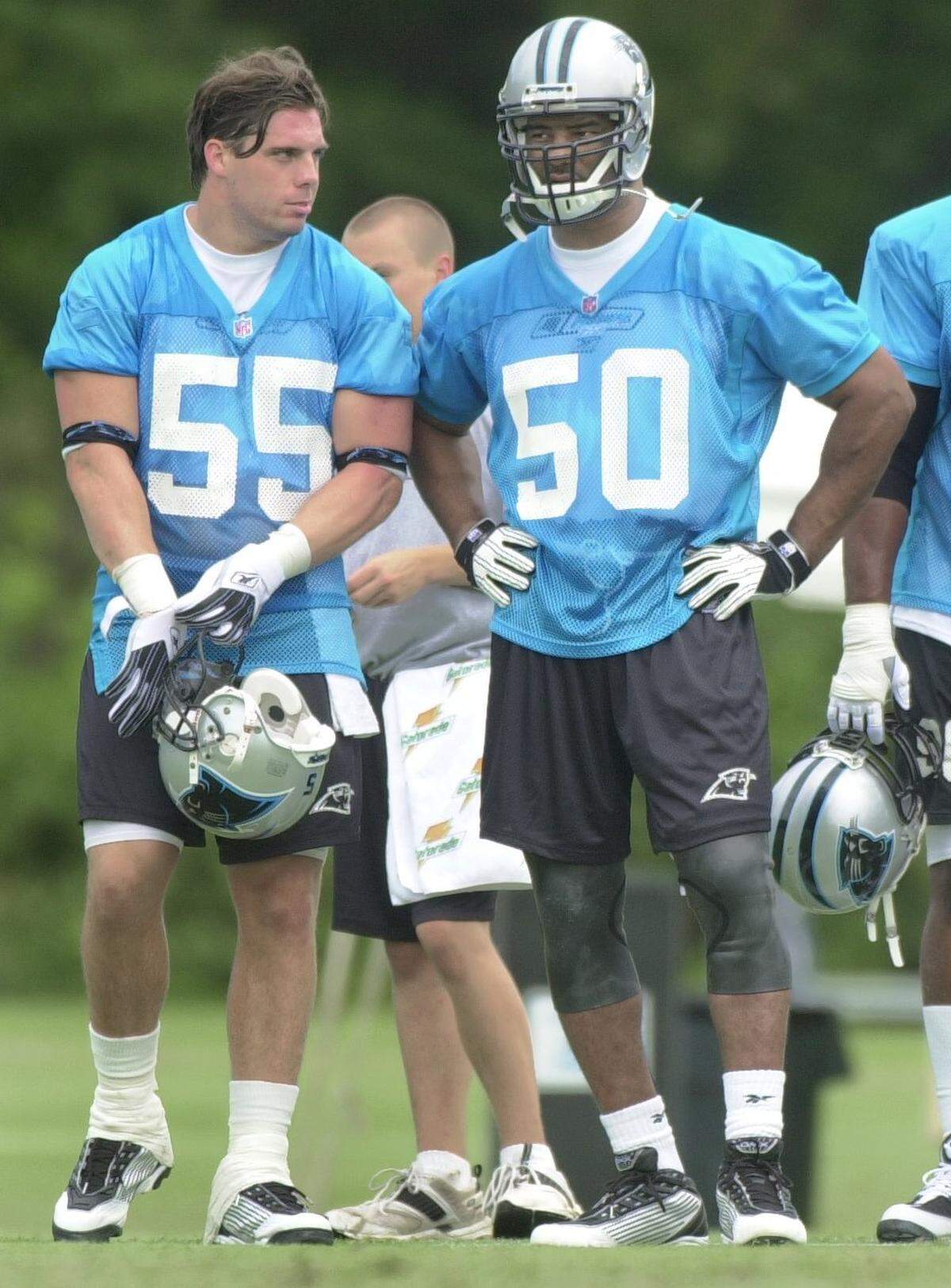 7/26/01: First-round draft pick Dan Morgan (55) confers with new Panther Chris Slade (50) at training camp Thursday at Wofford College in Spartanburg.