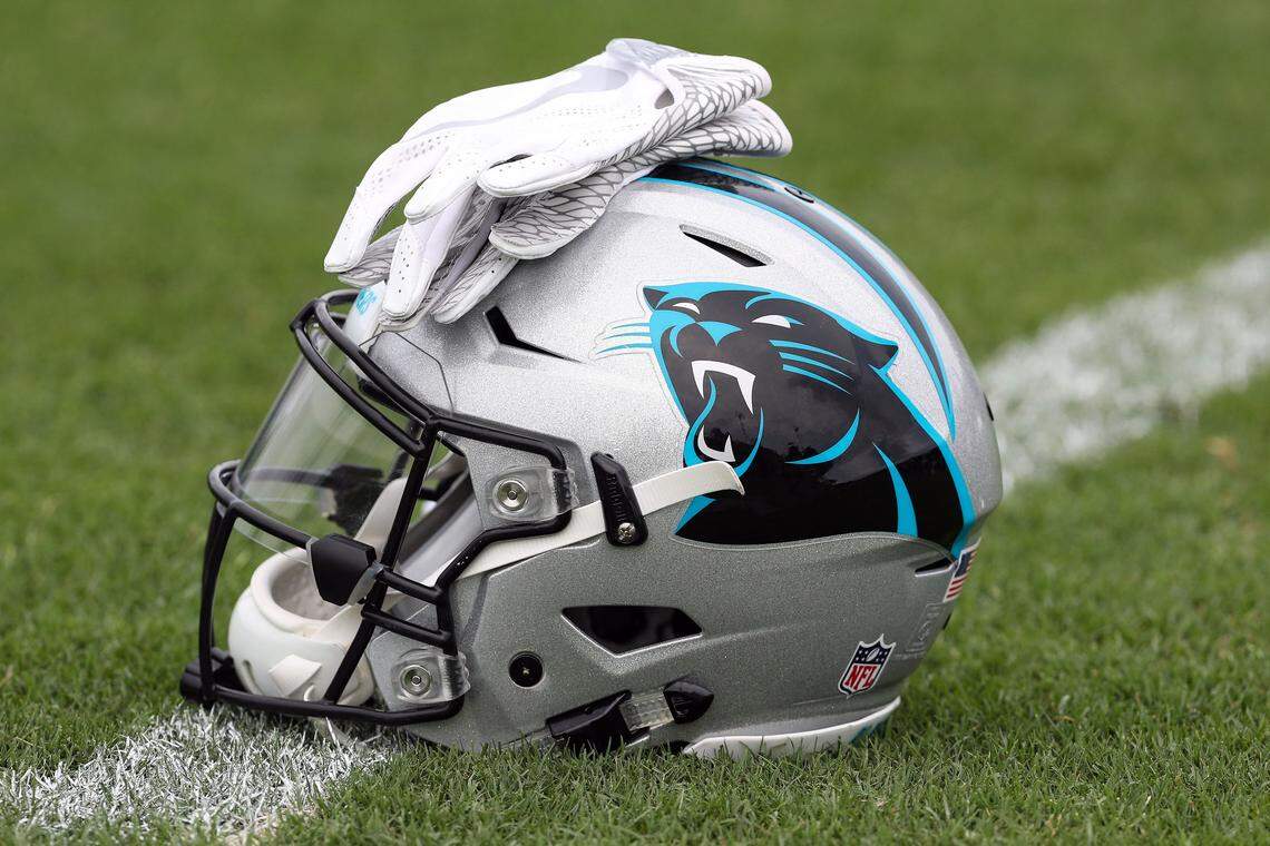 Jul 27, 2017; Spartanburg, SC, USA; Carolina Panthers logo helmet and gloves wait on the turf during Panthers Training Camp at Wofford College. Mandatory Credit: Jim Dedmon-USA TODAY Sports