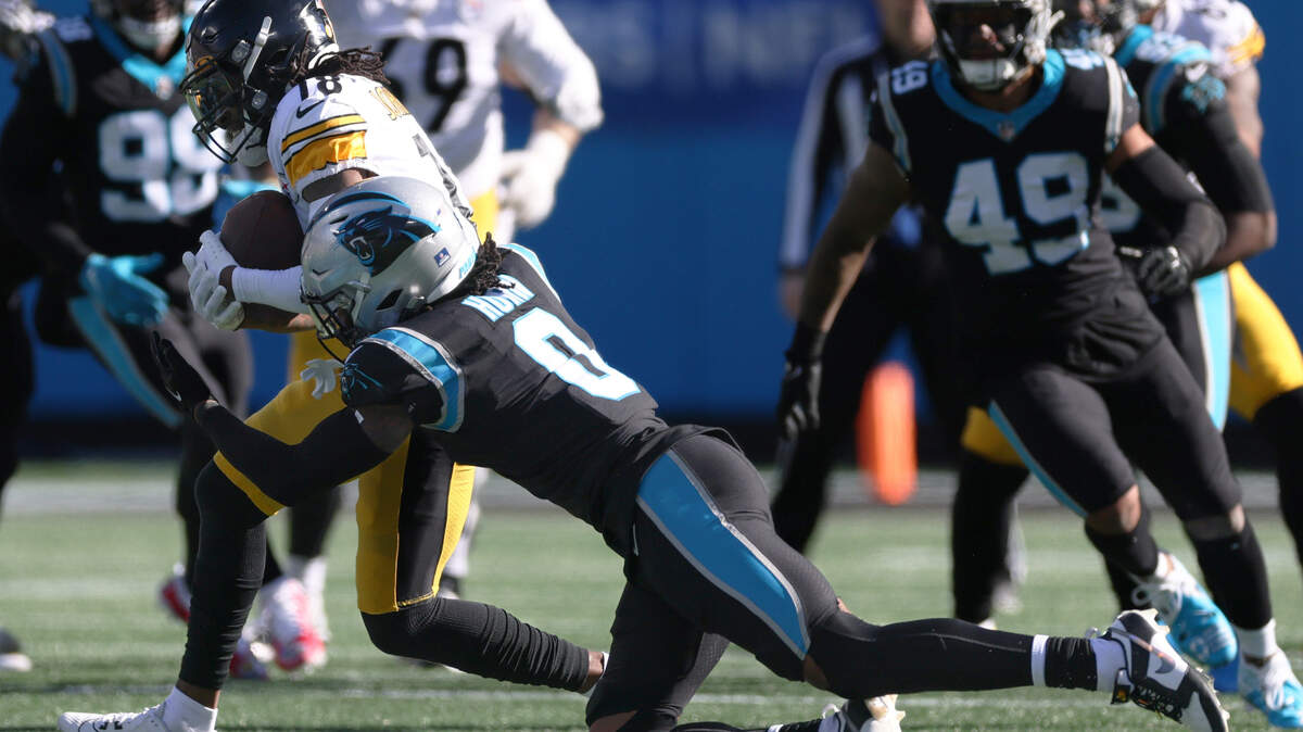 Pittsburgh Steelers wide receiver Diontae Johnson (18), left, is tackled by Carolina Panthers cornerback Jaycee Horn (8) at the Bank of America Stadium in Charlotte, N.C., on Sunday, December 18, 2022.
