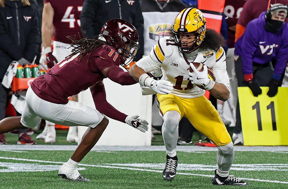 Minnesota Golden Gophers wide receiver Elijah Spencer, right, turns to pick up extra yardage following a pass reception as Virginia Tech safety Devin Alves, left, looks to make the tackle during the Duke’s Mayo Bowl at Bank of America Stadium in Charlotte, NC on Friday, January 3, 2025.