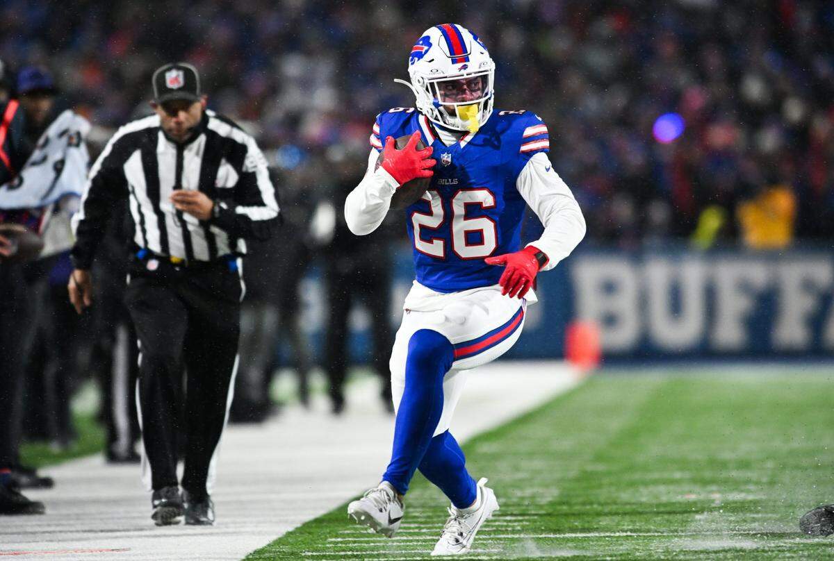 Jan 19, 2025; Orchard Park, New York, USA; Buffalo Bills running back Ty Johnson (26) runs the ball during the fourth quarter against the Baltimore Ravens in a 2025 AFC divisional round game at Highmark Stadium. Mandatory Credit: Mark Konezny-Imagn Images
