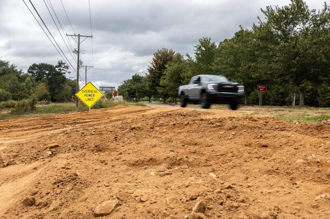 Langtree Road near I-77 Exit 31 is pictured beside construction of the East West Connector in Mooresville, N.C., on Friday, September 13, 2024. Two years from completion, the connector has already attracted major housing subdivisions and a planned mega mixed-used community.