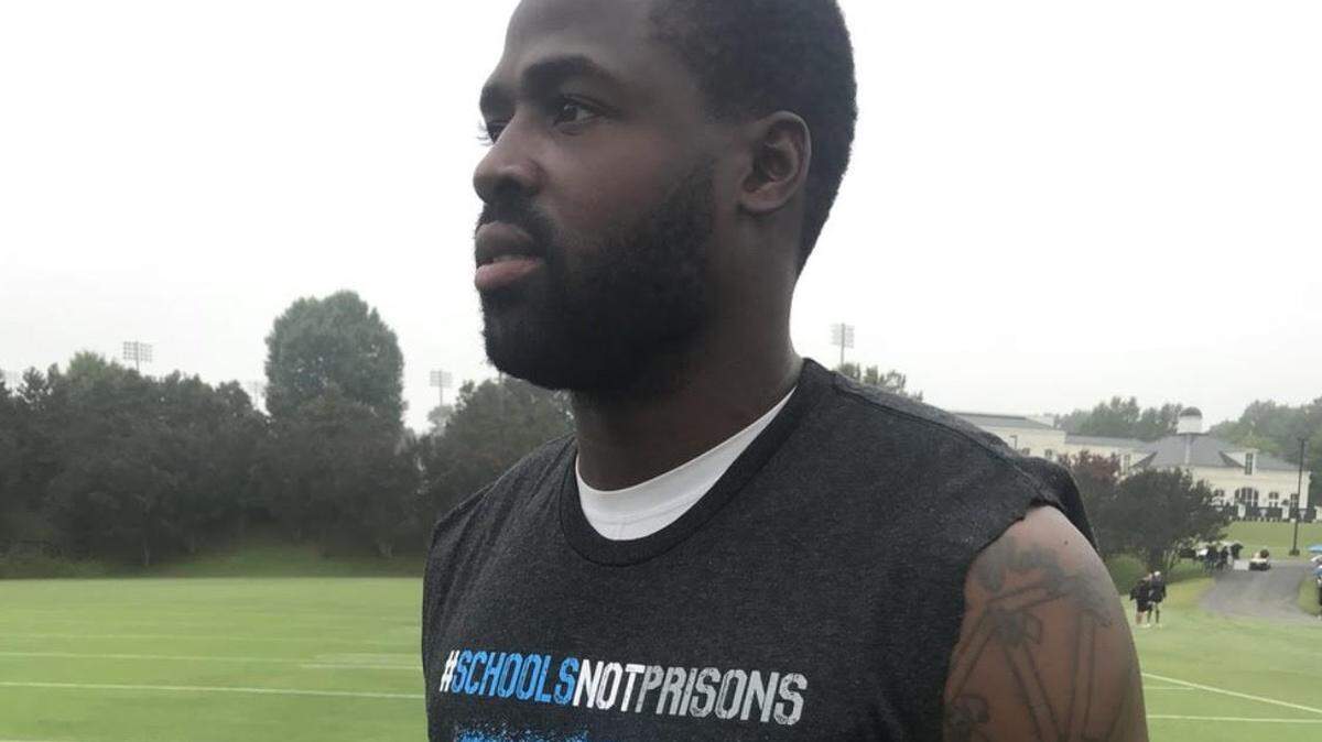 Carolina Panthers wide receiver and social activist Torrey Smith wore a T-shirt to practice on Wednesday that featured the hashtag #SchoolsNotPrisons.