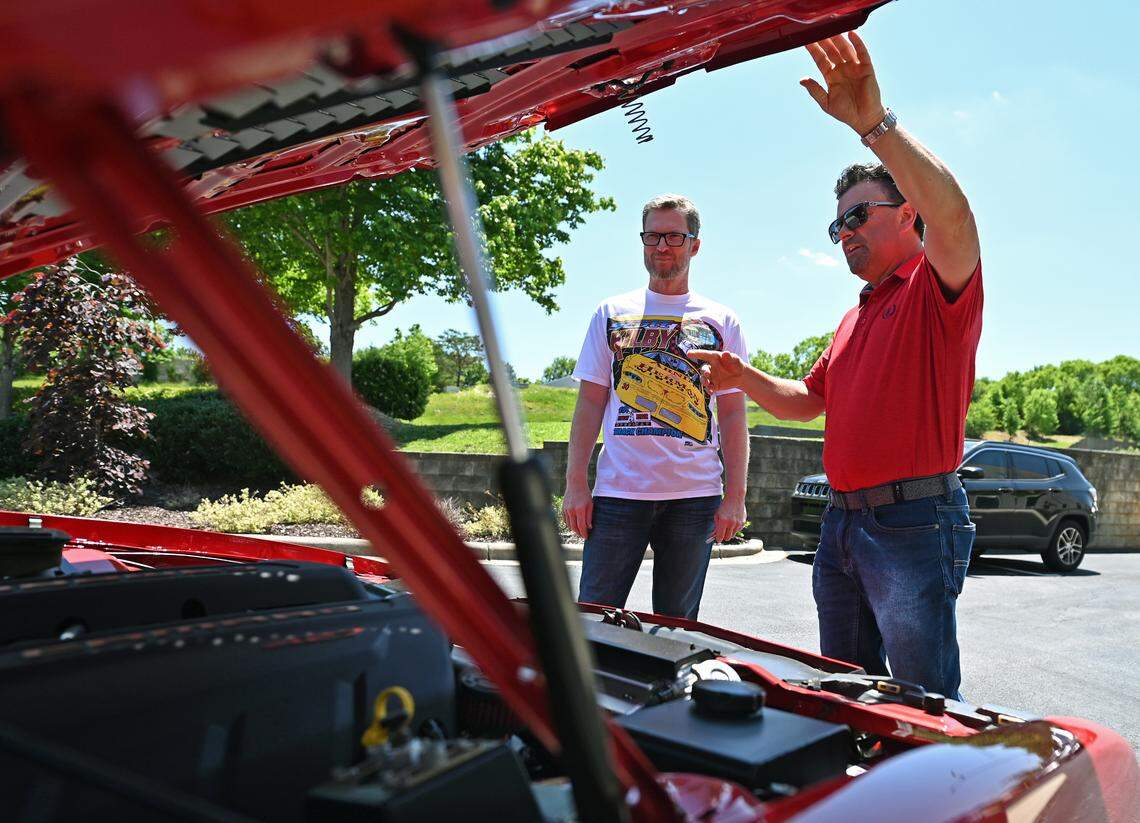 NASCAR driver and hall of fame member Dale Earnhardt Jr., left, looks at an IROC Camaro a fan drove to JR Motorsports in Mooresville, NC on Tuesday, May 17, 2022.