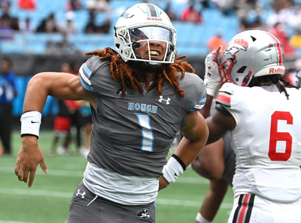 Hough Huskies quarterback Ethan Royal celebrates his touchdown run against the South Pointe Stallions during the Keep Pounding Classic at Bank of America Stadium in Charlotte on Friday, Aug. 22, 2025.