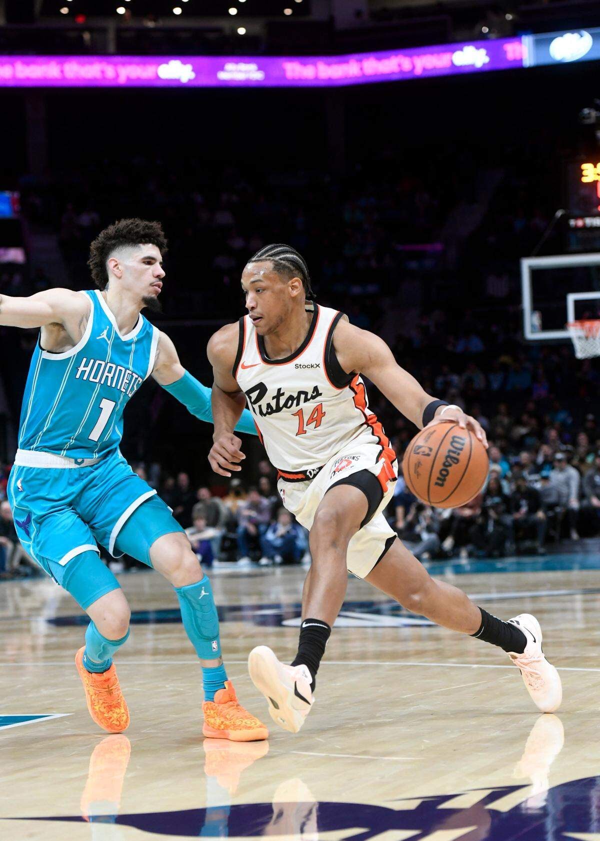 Nov 21, 2024; Charlotte, North Carolina, USA; Detroit Pistons guard Wendell Moore Jr. (14) drives past Charlotte Hornets guard LaMelo Ball (1) during the first half at the Spectrum Center. Mandatory Credit: Sam Sharpe-Imagn Images