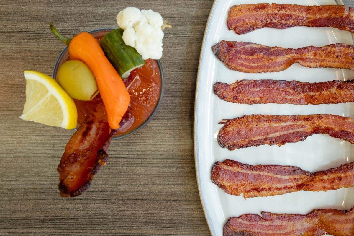 Snooze An A.M. Eatery packs its Bloody Marys with a lemon wedge, olive, pepper, cucumber and cauliflower — and you can add on bacon.
