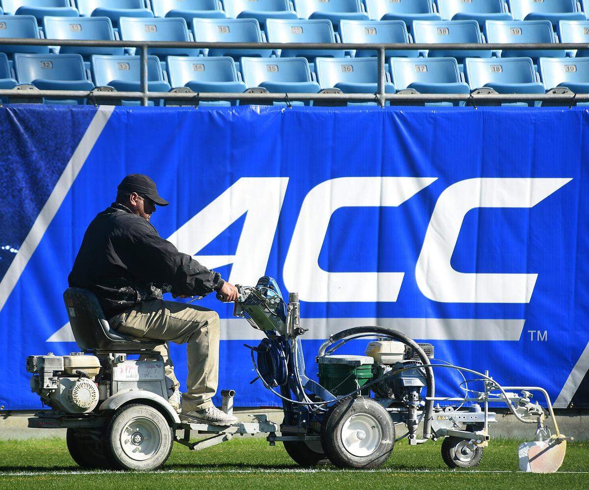 A worker paints lines on the field at Bank of America Stadium ahead of the 2017 ACC Football Championship Game in Charlotte, NC. This year’s game will feature No. 17 Pitt and No. 18 Wake Forest on Saturday, Dec. 4, 2021.