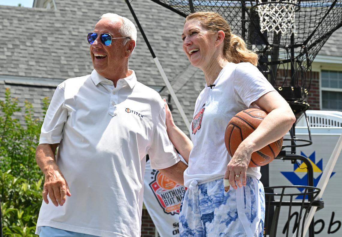 Former North Carolina head basketball coach Roy Williams, left, jokes with former North Carolina State women’s basketball player and current college basketball analyst Debbie Antonelli, right, during her 24 Hours of Nothing But Net event to help Special Olympics on Saturday, May 13, 2023. Williams stopped by Antonelli’s home to offer support. Antonelli shoots and makes 100 free throws every hour for 24 hours.