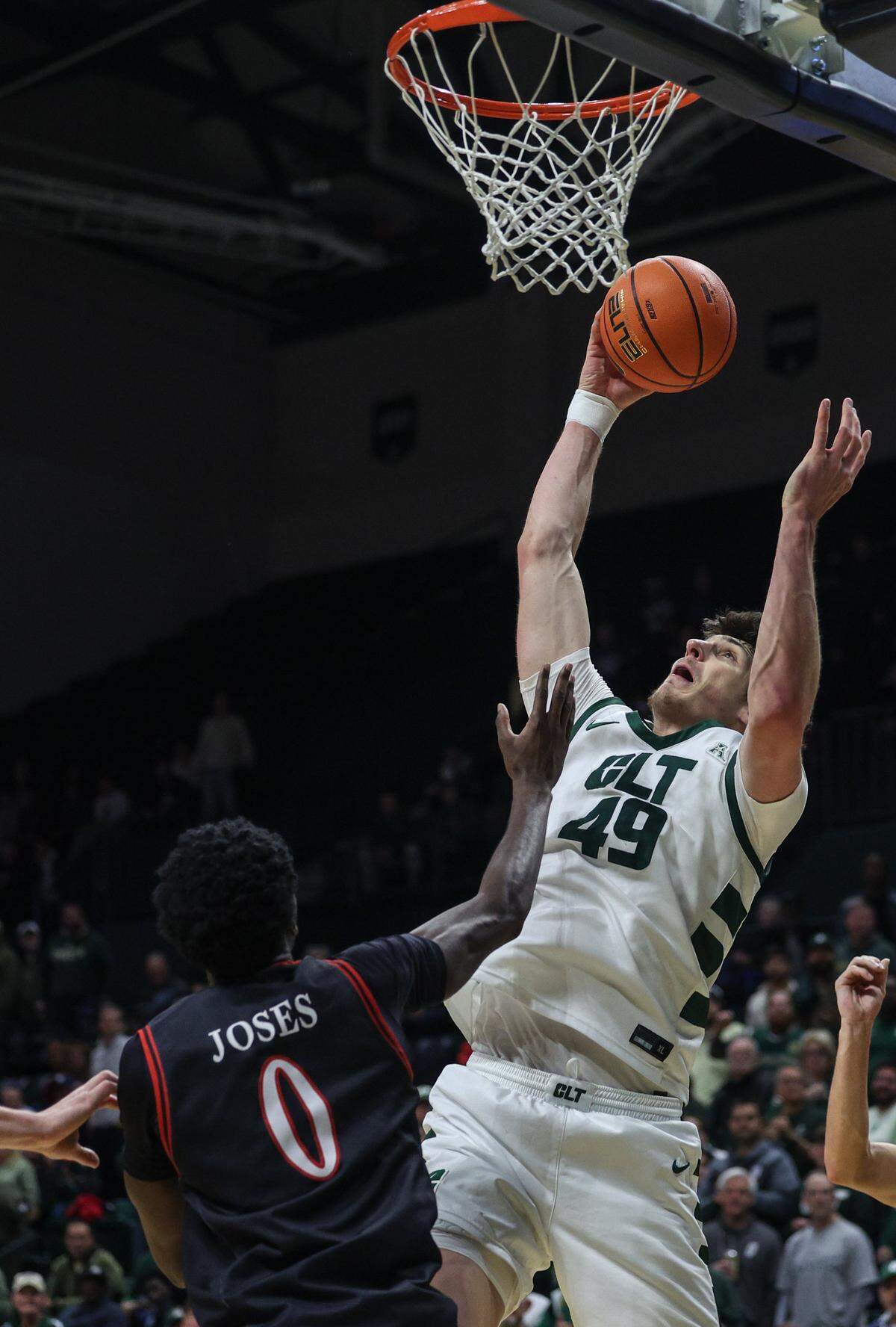 Charlotte center Anton Bonke, right, takes the ball to the hoop over Davidson forward Manie Joses during the game at Dale F. Halton Arena on Tuesday, November 11, 2025.