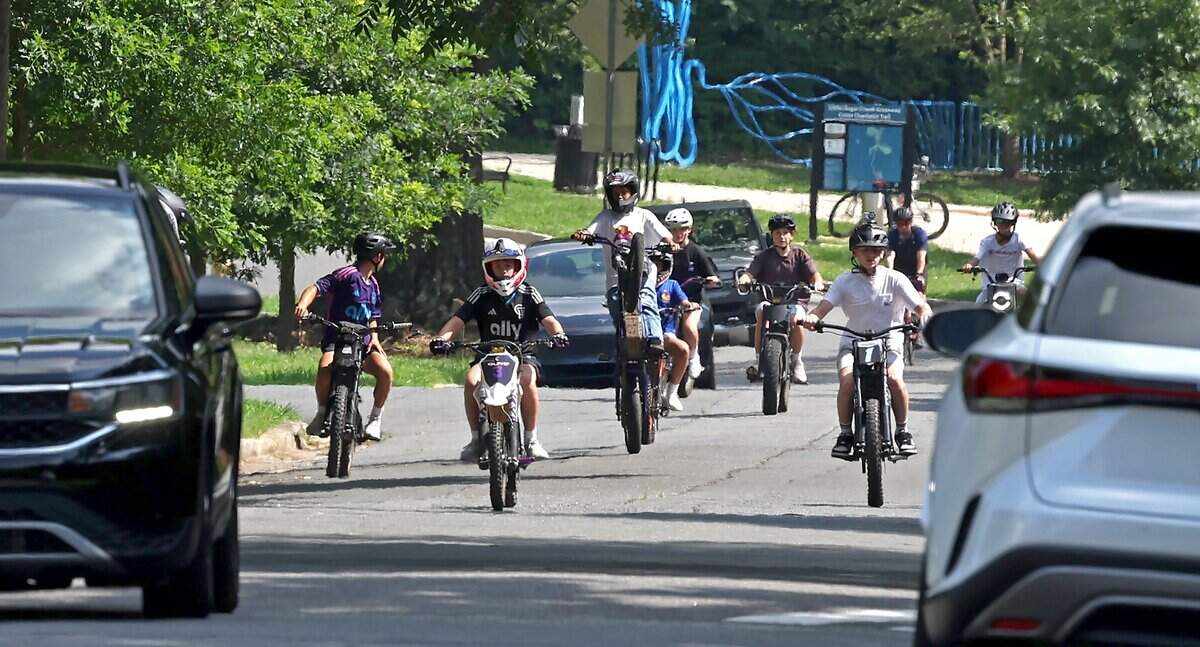 Youngsters enjoy riding their e-bikes down Westfield Road in Charlotte, NC on Tuesday, June 30, 2026.