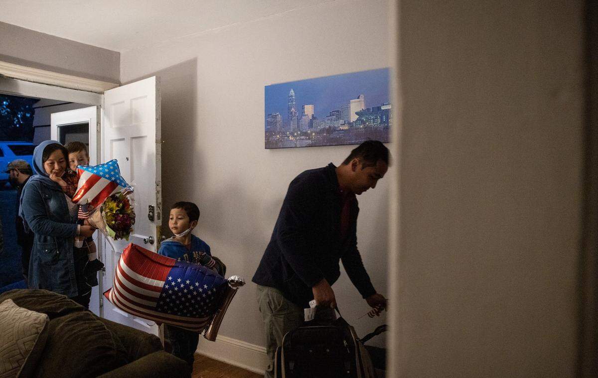Hamid, right, and his family arrive in their temporary home in Charlotte, on Nov. 9, 2021.