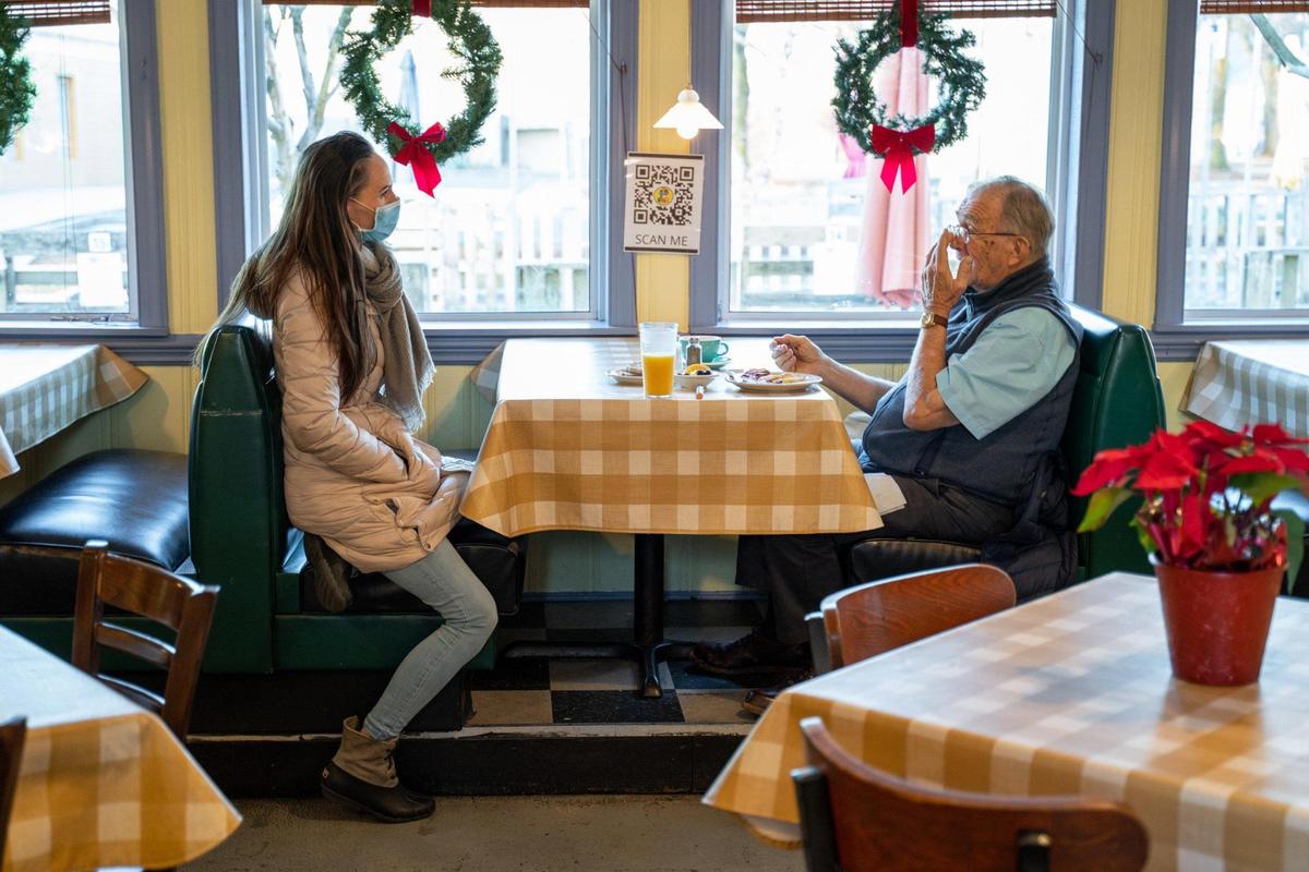 Former Sammy’s Deli employee Christina Black talks to former Sammy’s regular Bob Killough while he eats breakfast at Dish, where they’ve both landed.