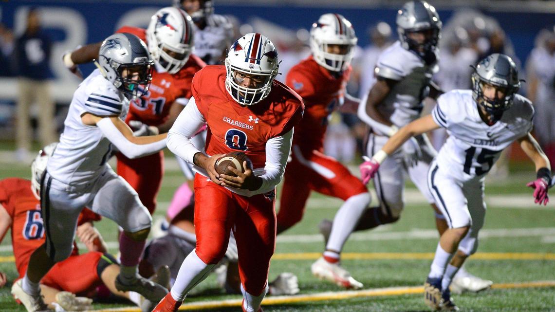 Providence Day Chargers quarterback Grantt Logan rushes for a touchdown against Charlotte Latin during second quarter action on Friday, October 29, 2021 at Providence Day School in Charlotte, NC.