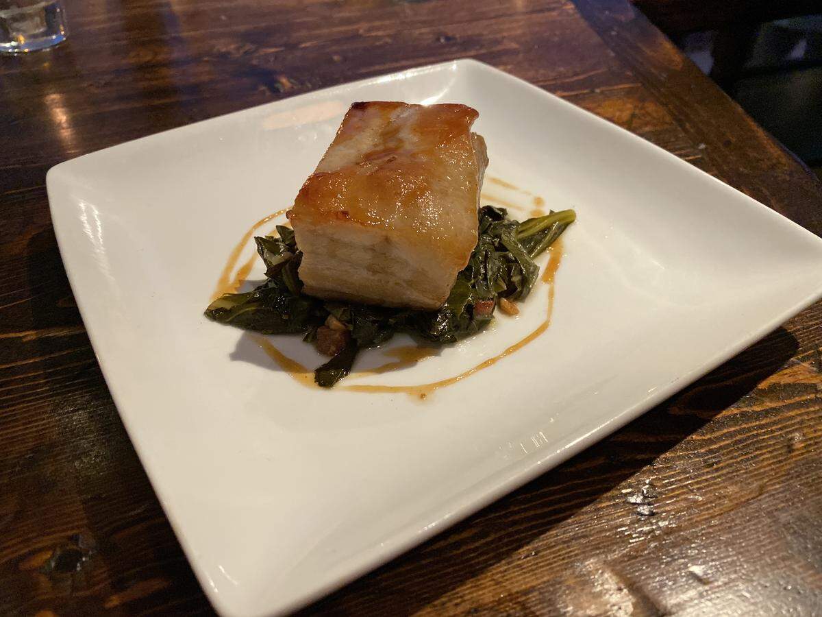 Belmont Country Club’s Pork belly confit has pasture-raised heritage pork, Carolina braised collards, maple cider reduction.