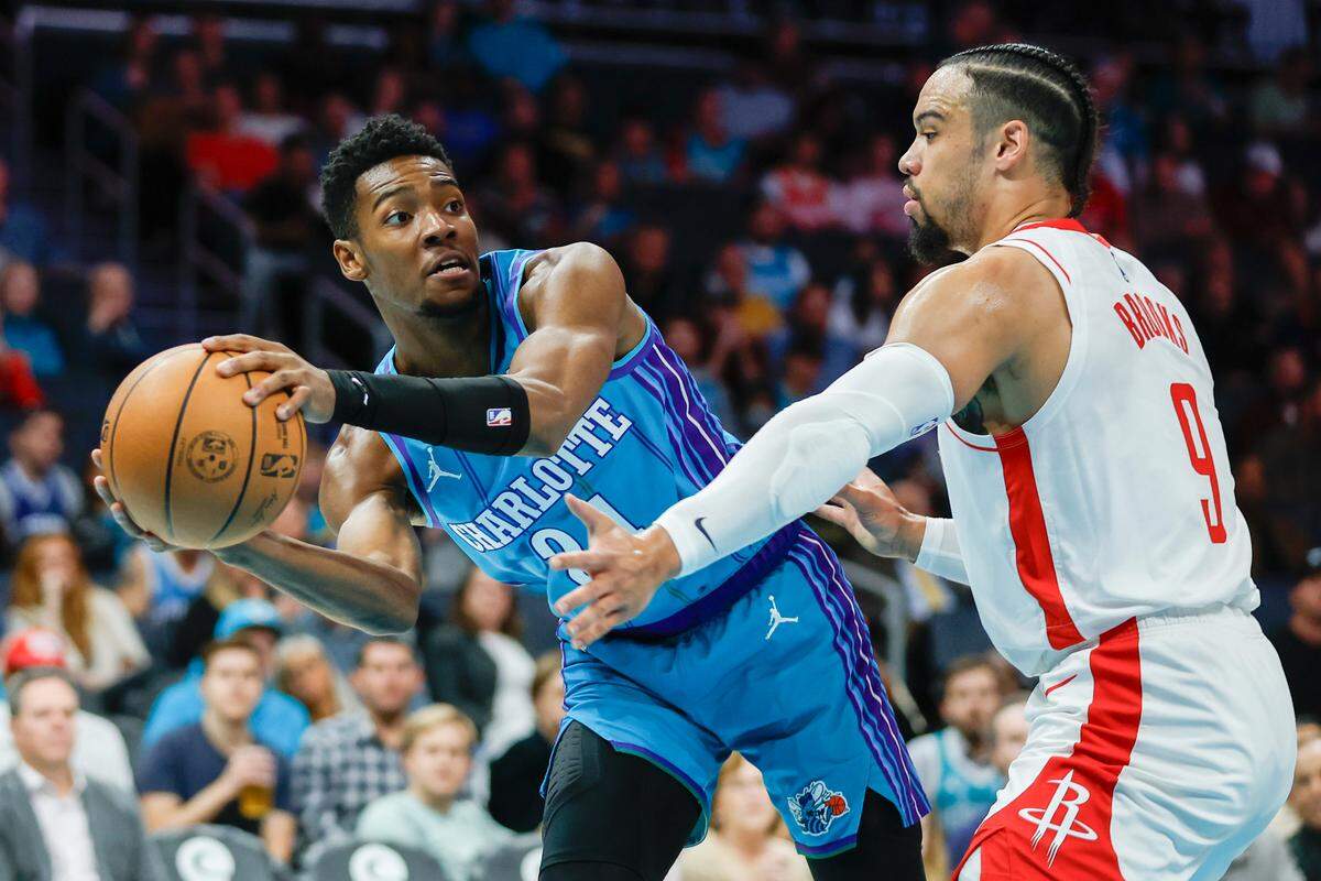 Jan 26, 2024; Charlotte, North Carolina, USA; Charlotte Hornets forward Brandon Miller (24) looks to pass around Houston Rockets forward Dillon Brooks (9) during the first quarter at Spectrum Center.