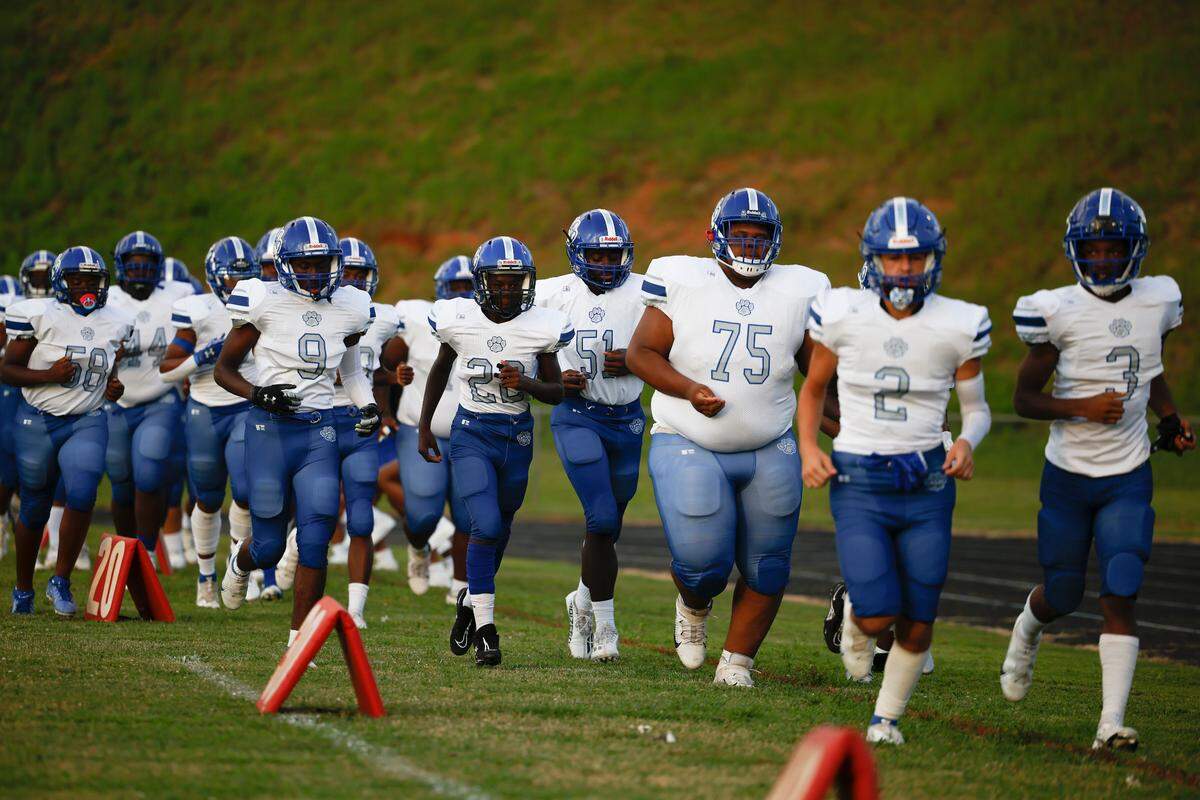 Garinger takes the field before a game against West Charlotte at Waddell High School in Charlotte, N.C., Thursday, Sept. 8, 2022. West Charlotte beat Garinger 48-8.