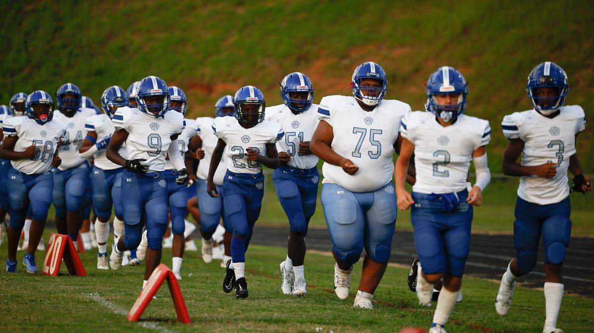 Garinger takes the field before a game against West Charlotte at Waddell High School in Charlotte, N.C., Thursday, Sept. 8, 2022. West Charlotte beat Garinger 48-8.