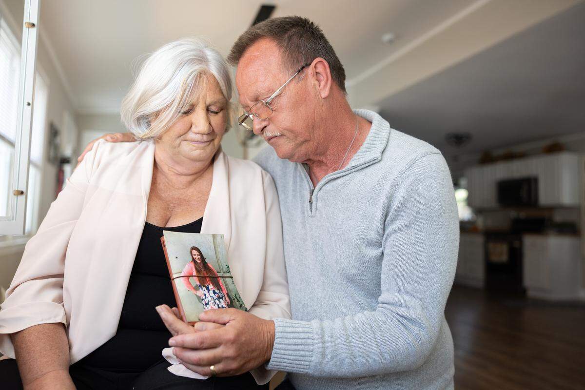 Debora Savage and her husband hold a photo of their daughter in Mooresville in November 2025. Tylor was 26 years old when she died following weight loss surgery. 