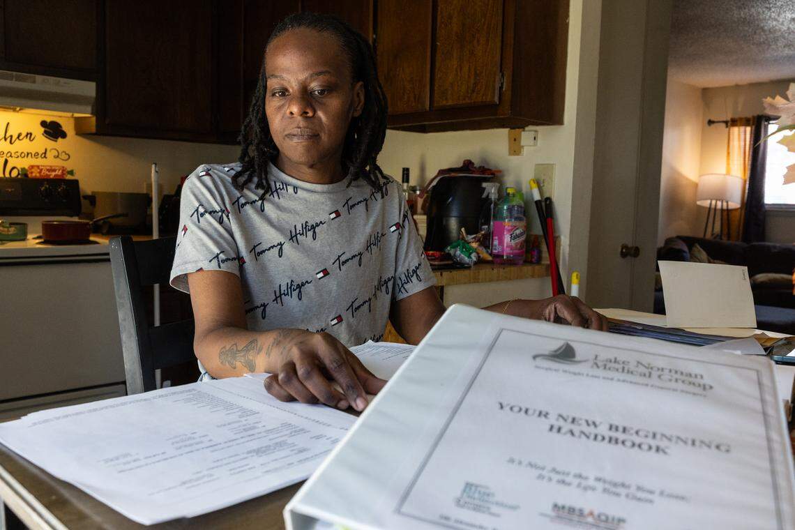 Tawanna Chambers looks through documents related to her surgery at home in Albemarle. 