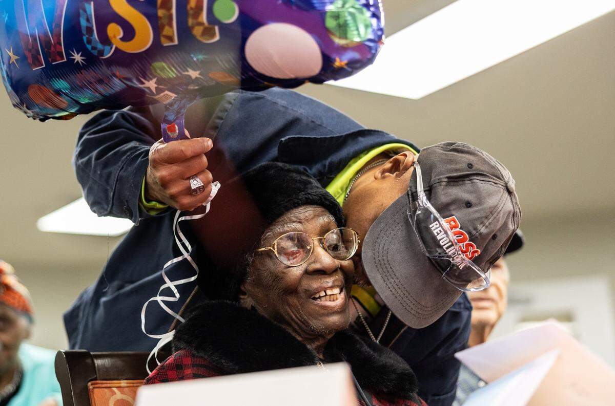 Julia Ann Teamer is greeted by her nephew, Howard Mcknight, during her 108th birthday celebration at her retirement community in Charlotte, N.C., on Thursday, January 16, 2025.