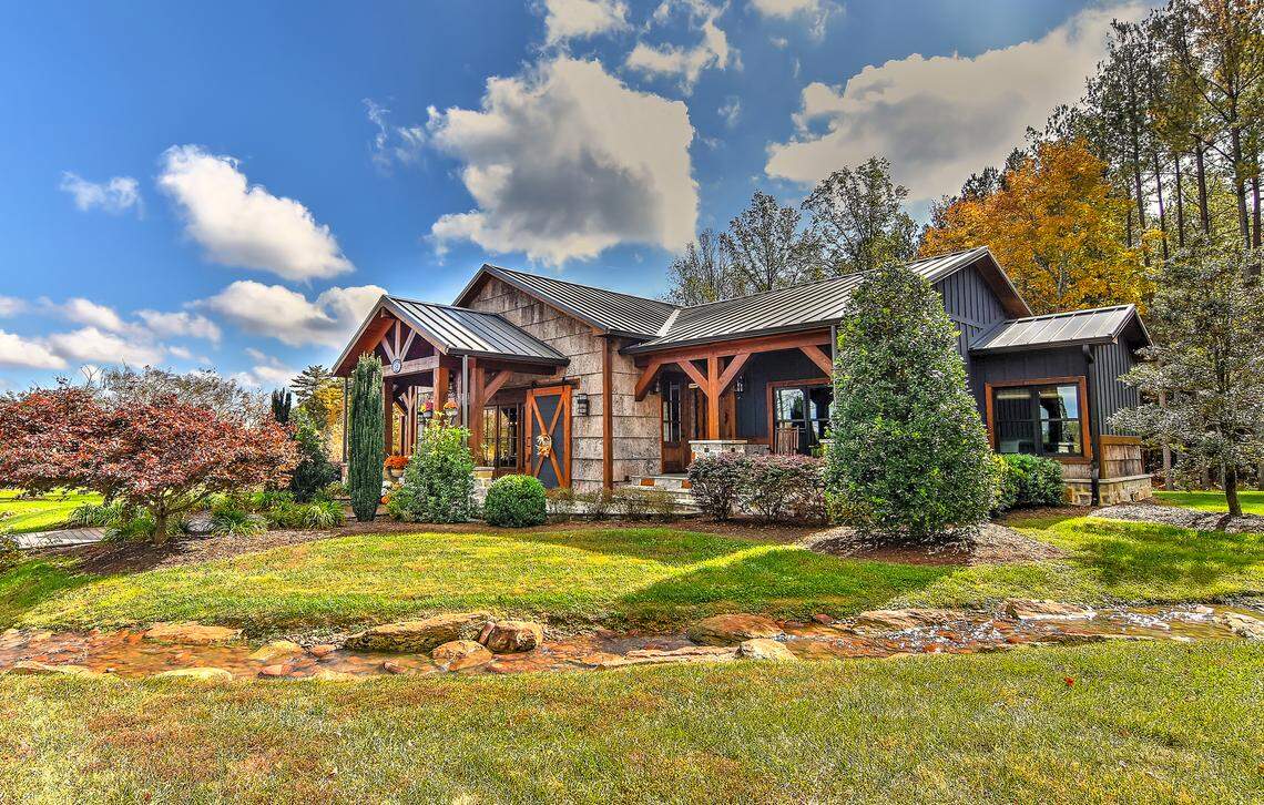 The property at 153 Badenyon Pl. is nestled on a beautifully landscaped property with rich wood accents surrounded by mature trees.