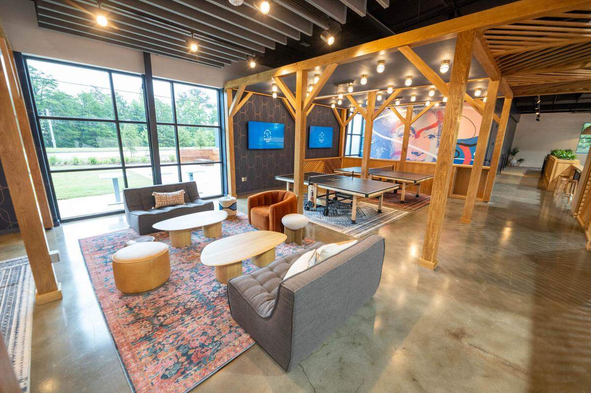 Rally combines pickleball with food, cocktails and coffee. Shown above is a lounge and two of the four ping pong tables at Rally.
