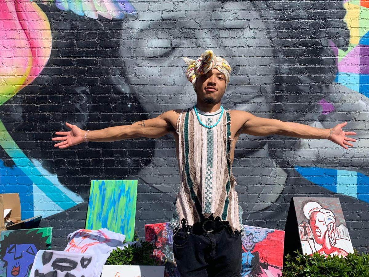 Xavier The Artist, a local painter, sells his work in NoDa and says he and his fellow street vendors are part of the neighborhood’s artsy feel.