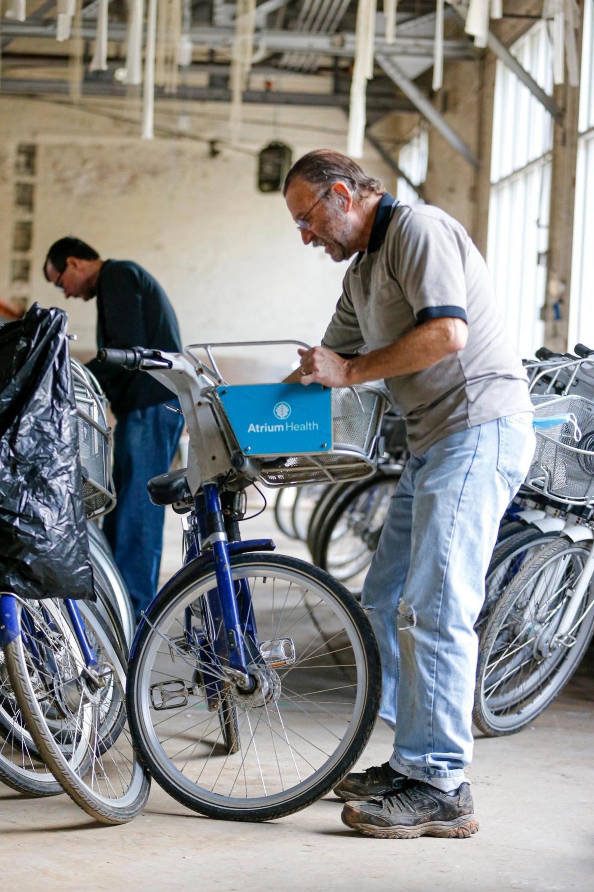 Jonathan Wells, right, and Brad Patterson work on bicycles that are being restored and donated to Roof Above to help homeless people with transportation needs.