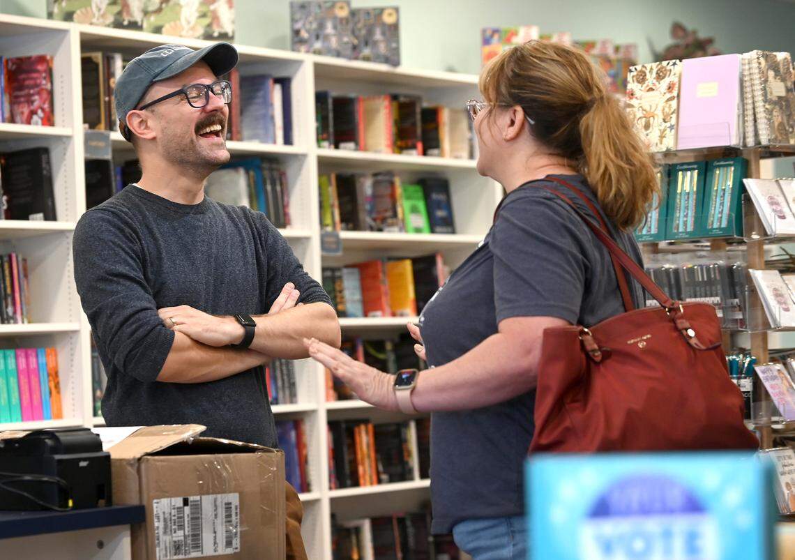 Troubadour Booksellers owner Scott Tynes-Miller, left, speaks with Dawn Evans, owner of Editions Coffee Shop and Book Store in Kannapolis, at his independent book store in Sardis Crossing in east Charlotte.