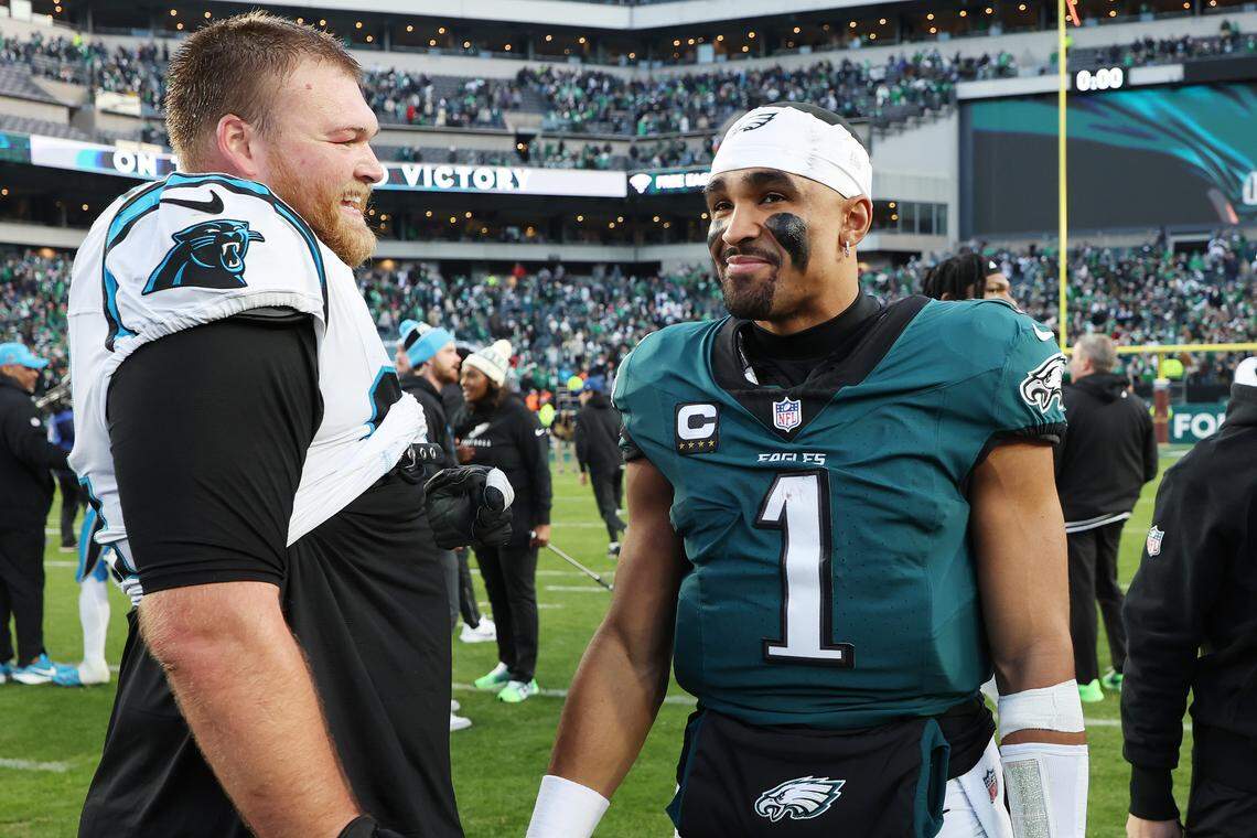 Philadelphia Eagles quarterback Jalen Hurts (right) talks to Carolina Panthers center Cade Mays (left) after a game at Lincoln Financial Field on Dec. 8, 2024 in Philadelphia. (Photo by Emilee Chinn/Getty Images)