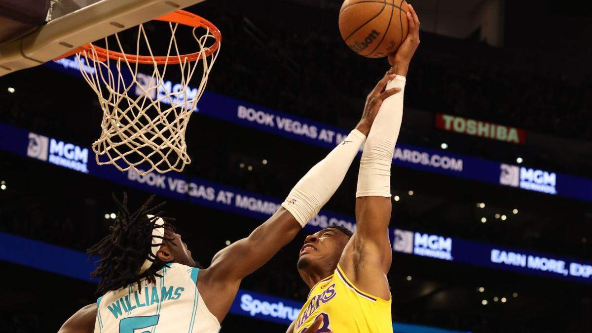 Feb 19, 2025; Los Angeles, California, USA; Los Angeles Lakers forward Rui Hachimura (28) shoots against Charlotte Hornets center Mark Williams (5) during the first quarter at Crypto.com Arena. Mandatory Credit: Jason Parkhurst-Imagn Images
