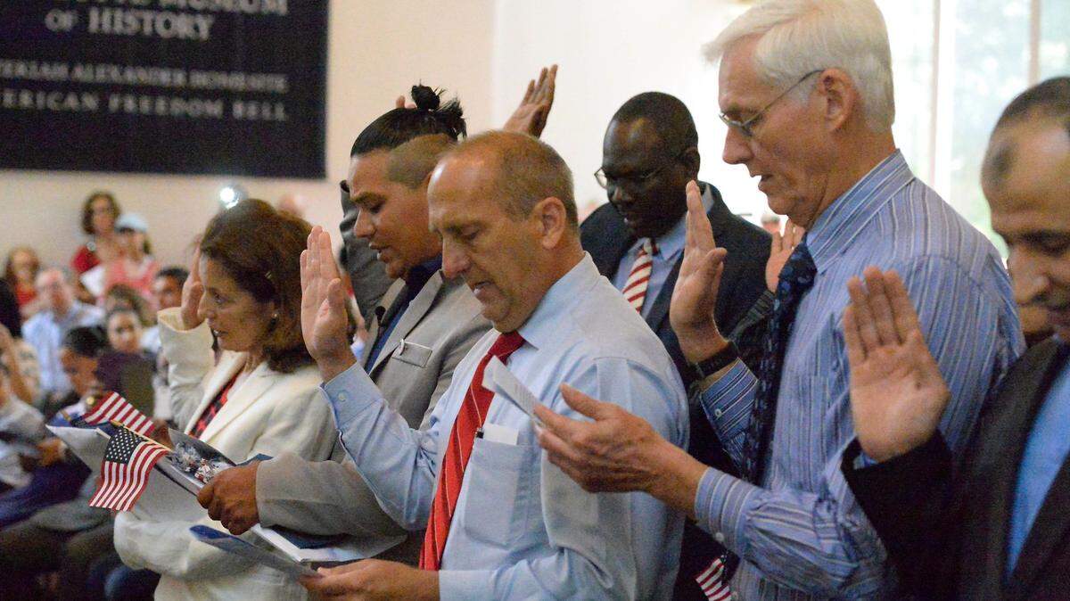 U.S. citizenship candidates take the oath of allegiance during an Independence Day Naturalization Ceremony at the Charlotte Museum of History on Wednesday, July 4, 2018.