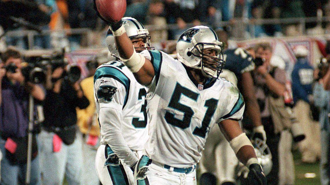 Sam Mills shows the ball to the hometown crowd in the 4th quarter following his interception in the Panthers’ first-ever playoff win, a 26-17 victory over the Dallas Cowboys in the 1996 postseason. Mills made the Pro Football Hall of Fame Thursday night.