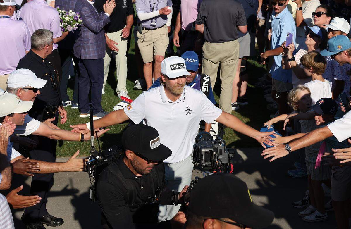 Golfer Kristoffer Reitan slaps hands with fans after winning the Truist Championship at Quail Hollow Club in Charlotte, NC on Sunday, May 10, 2026. Reitan won the Truist Championship finishing at -15.