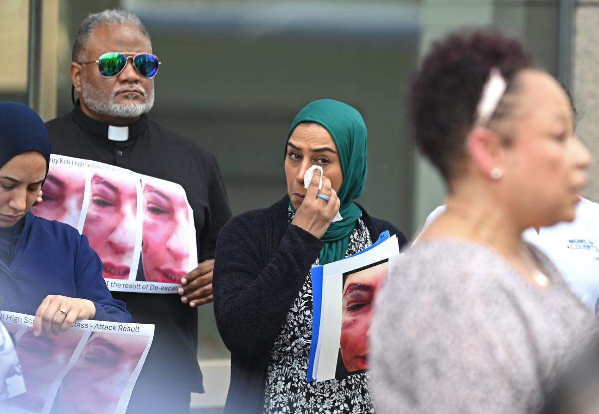 Maliha Ali, center, wipes away a tear during an April 4 press conference in the case of the 15-year-old female Ardrey Kell High student whose family says was attacked by a football player who had bullied her with anti-Muslim comments.