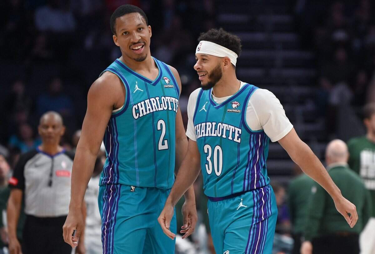 Charlotte Hornets forward Grant Williams, left and guard Seth Curry, right, joke during action against the Milwaukee Bucks at Spectrum Center in Charlotte, NC on Thursday, February 29, 2024.