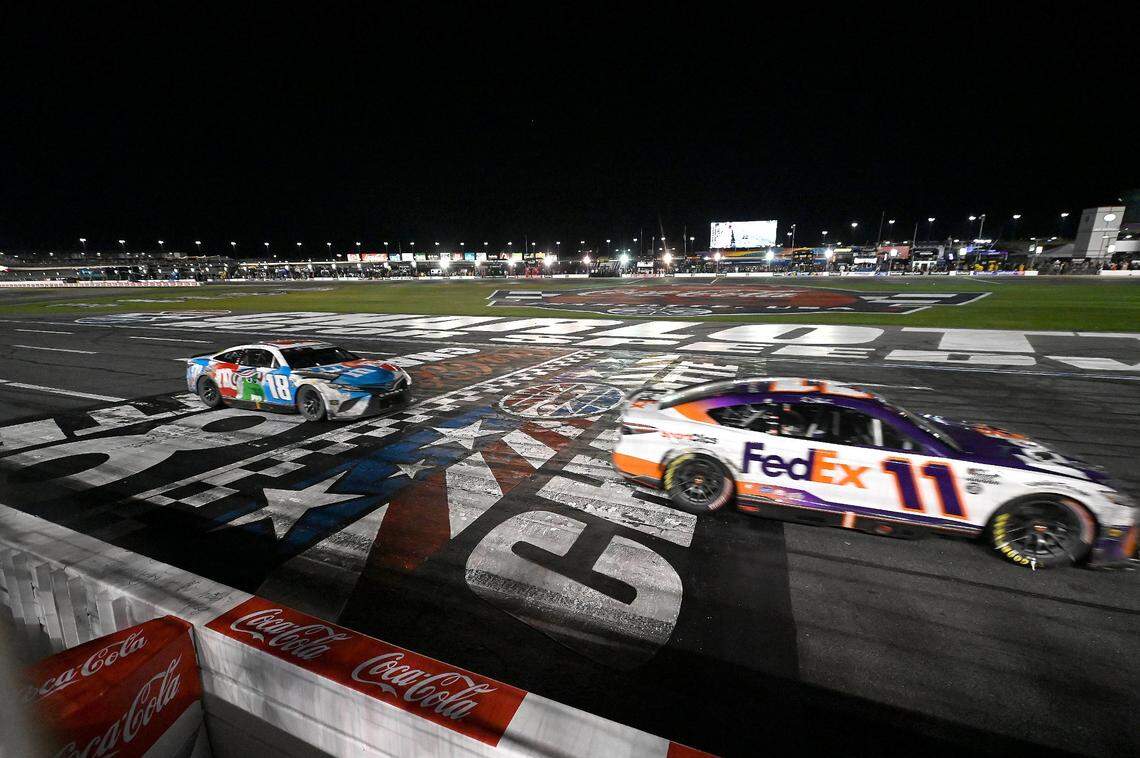 NASCAR driver Denny Hamlin crosses the finish line to win the Coca-Cola 600 at Charlotte Motor Speedway on Sunday, May 29, 2022. Hamlin held off Kyle Busch for the victory.