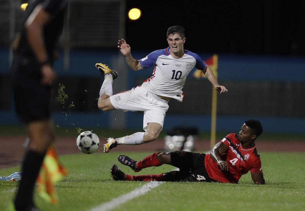 United States’ Christian Pulisic, top, reacts after being fouled by Trinidad and Tobago’s Kevon Villaroel during a 2018 World Cup qualifying&nbsp;soccer&nbsp;match in Couva, Trinidad, Tuesday, Oct. 10, 2017. (AP Photo/Rebecca Blackwell)