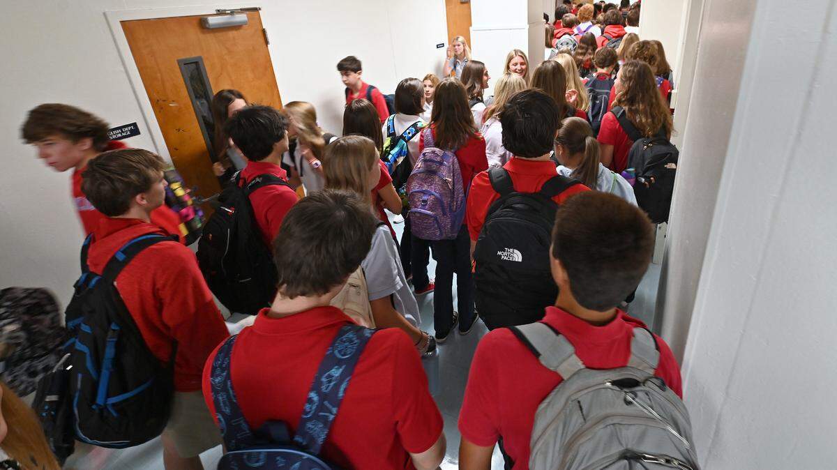 Charlotte Catholic High School students change classes on Wednesday, August 16, 2023.