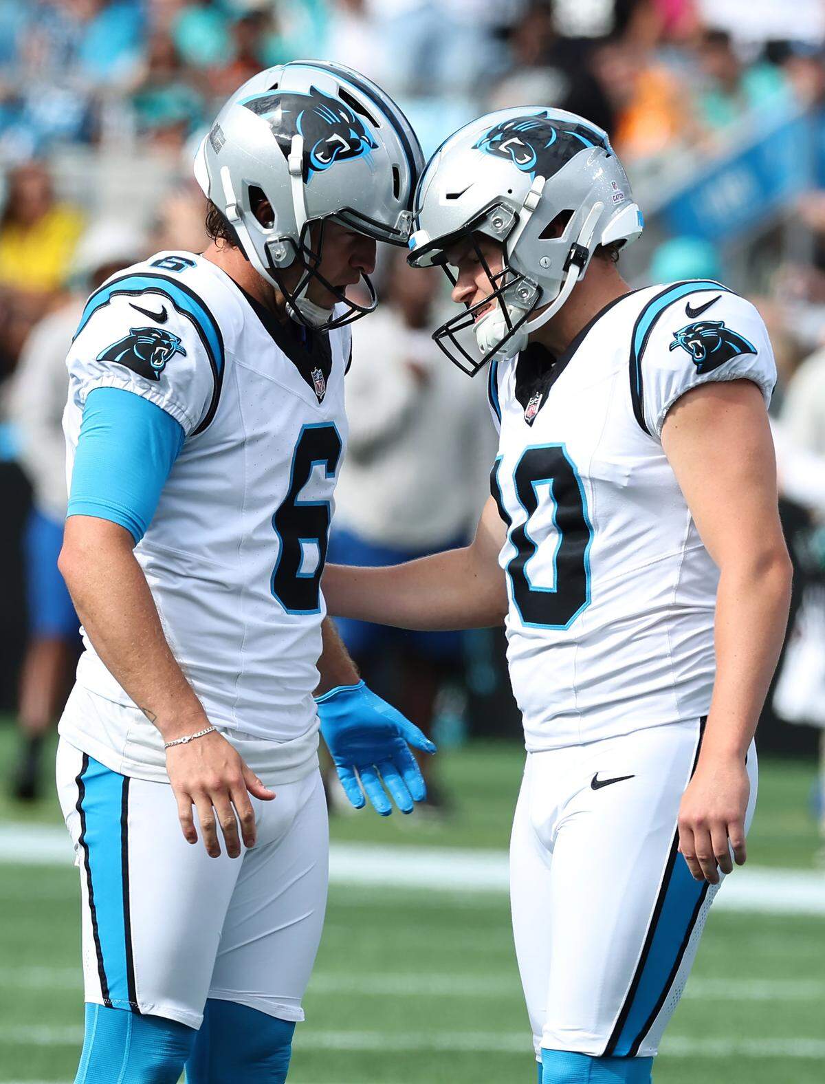 Carolina Panthers punter Sam Martin, left and kicker Ryan Fitzgerald, right, bumps helmets following Fitzgerald's extra point kick against the Miami Dolphins on Sunday, October 5, 2025 at Bank of America Stadium in Charlotte, NC. The Panthers defeated the Dolphins 27-24.