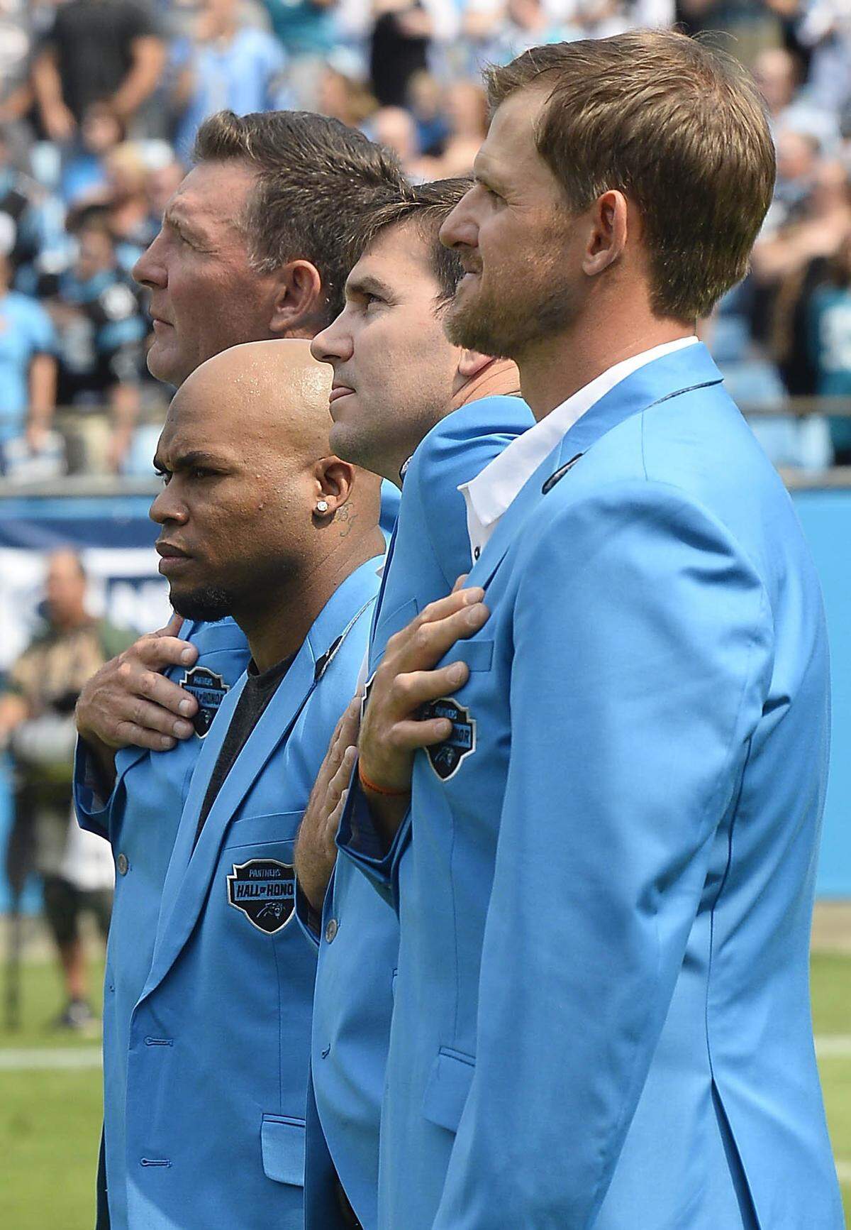 Former Carolina Panthers players Wesley Walls, left, Steve Smith, Sr, Jake Delhomme and Jordan Gross stand for the National Anthem prior to the team playing the Jacksonville Jaguars at Bank of America Stadium in Charlotte, NC on Sunday, October 6, 2019. The Panthers won, 34-27. All four of the players were inducted into the team’s Hall of Honor at halftime of the game.