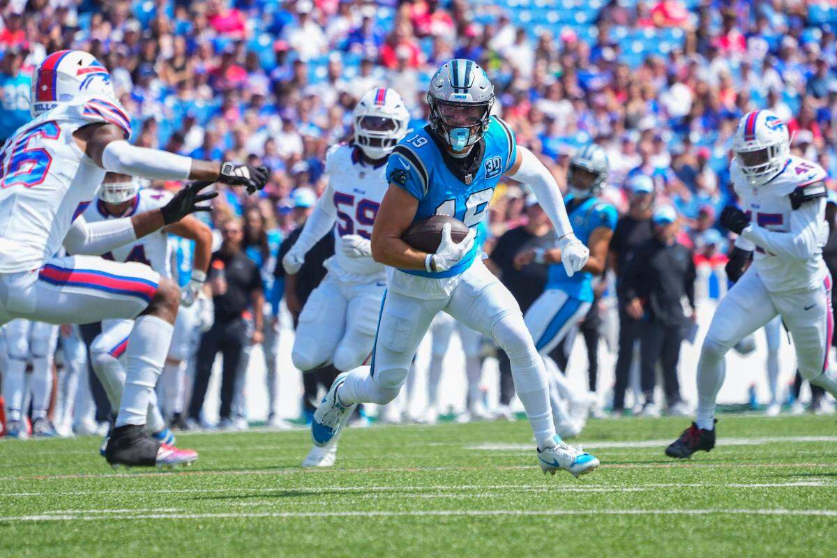Carolina Panthers wide receiver Adam Thielen runs with the ball after making a catch against the Buffalo Bills during a 2024 game at Highmark Stadium.