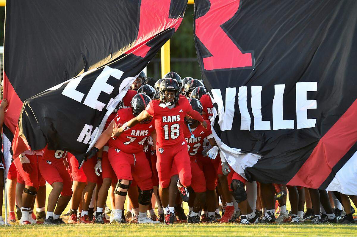 Rolesville wide receiver Gavin Waddell (18) leads his team onto the field before their game against Providence Day. The Rolesville Rams and the Providence Day Chargers met in a non-conference football game in Rolesville, N.C. on August 29, 2025.