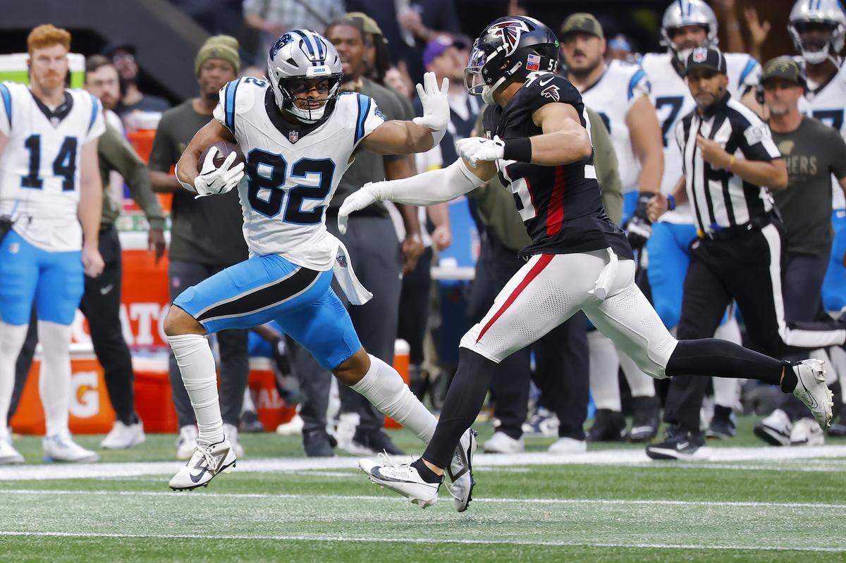 Carolina Panthers TE Tommy Tremble runs the ball after a catch against Atlanta Falcons LB Kaden Elliss during Sunday’s fourth quarter at Mercedes-Benz Stadium in Atlanta.