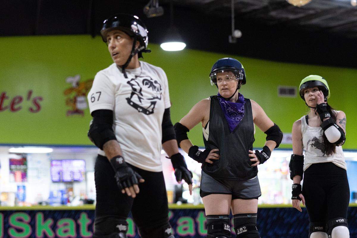 Lisa “Growler” Long, left, and Liz “Kansas” Zweigle take a break between jams at Charlotte Roller Derby practice at Kate’s Skating Rink in Indian Trail, N.C., on Sunday, July 30, 2023.