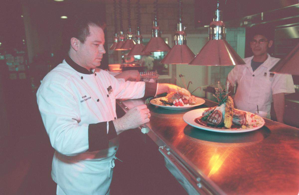 Chef and restaurateur Guy Ciecone, left, checks on a dish as Anthony Mascellino looks on at Guytano's Restaurant at 200 e. Bland St. in Charlotte in April 1999.